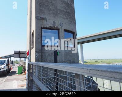 Iwade, Kent, UK. 20th Apr, 2020. Today is the 60th anniversary of the distinctive Kingsferry Bridge, linking Isle of Sheppey with mainland Kent, being opened by the Duchess of Kent on 20 Apr, 1960. At the time it was the largest lifting bridge built in Britain since the Second World War. There is only one other similar design in the world based in Holland. In 2006, the infamous Sheppey Crossing was opened, but Kingsferry was retained for rail and road traffic. A generator is in situ for lifting the centre span as the power system needs a replacement part. Credit: James Bell/Alamy Live News Stock Photo