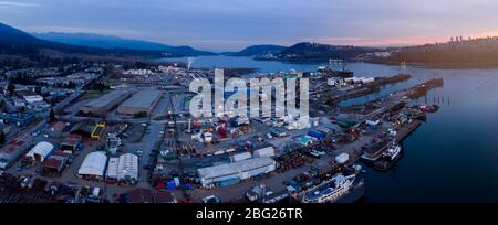 Aerial drone shot of a industrial shipyard and cargo ship loading port in Vancouver, BC, Canada. Stock Photo