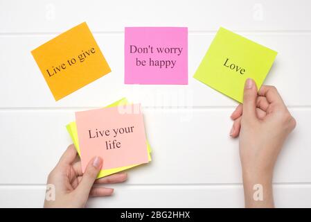 The hand lays out motivational cards. Color sheets with quotes. Visualization Board, self-discipline, development, training. Flat lay, top view. plan, Stock Photo