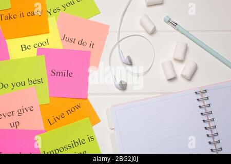 Daily planner, pen, headphones, and colorful word cards. Close-up on a white background. Copy space. Clean sheet, flat lay, top view.  To-do list, mar Stock Photo