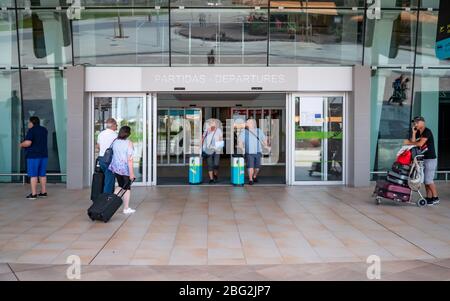 Faro International Airport, Portugal. Travellers leaving and entering the entrance to the departure terminal of the popular tourist resort airport. Stock Photo