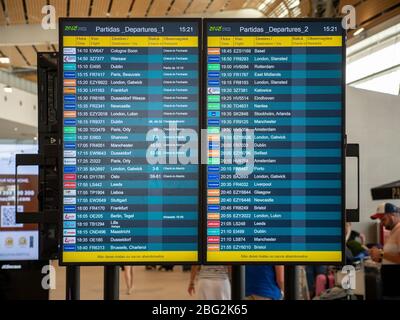 A flight departure board with information on times, gates, European locations and international airlines leaving from Faro Airport, Portugal. Stock Photo