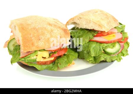 Sliced sandwich with ham and vegetables isolated on white Stock Photo