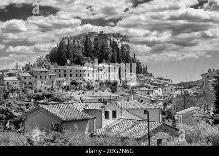 Magnificent black and white view of the ancient hilltop village of Cetona, Siena, Italy, on a beautiful sunny day with some white clouds
