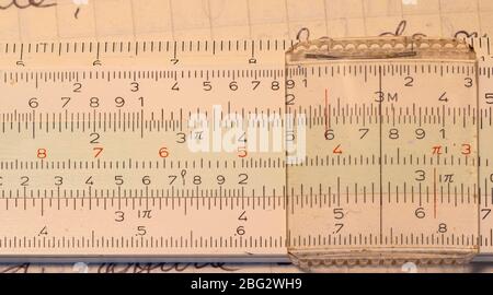 Cole up 1970s old Italian-made pocket slide rule mechanical calculator. Stock Photo