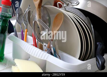 washing up in white plastic drainer Stock Photo