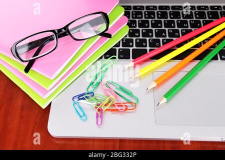 Laptop with stationery on table Stock Photo