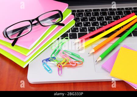 Laptop with stationery on table Stock Photo