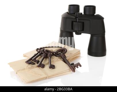 Black modern binoculars with old keys and letters isolated on white Stock Photo