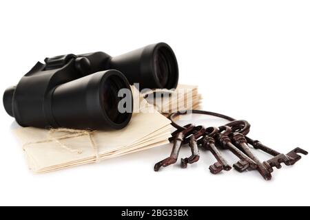 Black modern binoculars with old keys and letters isolated on white Stock Photo