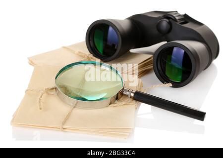Black modern binoculars with old letters isolated on white Stock Photo