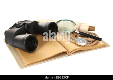 Black modern binoculars with old notebook isolated on white Stock Photo