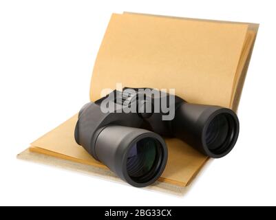 Black modern binoculars with old notebook isolated on white Stock Photo