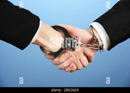 Man and woman hands and breaking handcuffs on color background Stock Photo