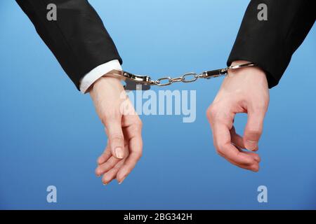 Man and woman hands and breaking handcuffs on color background Stock Photo