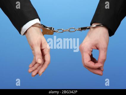 Man and woman hands and breaking handcuffs on color background Stock Photo