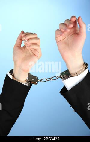 Man and woman hands and breaking handcuffs on color background Stock Photo