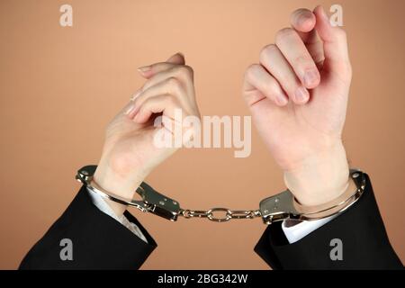 Man and woman hands and breaking handcuffs on color background Stock Photo