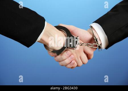 Man and woman hands and breaking handcuffs on color background Stock Photo