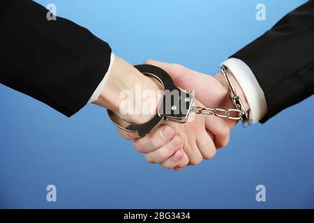 Man and woman hands and breaking handcuffs on color background Stock Photo