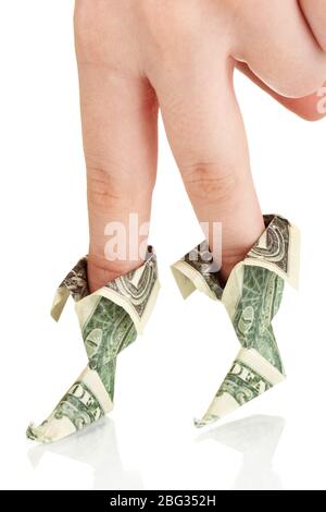 Dollars folded into boots on fingers of woman's hand isolated on white Stock Photo