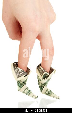 Dollars folded into boots on fingers of woman's hand isolated on white Stock Photo