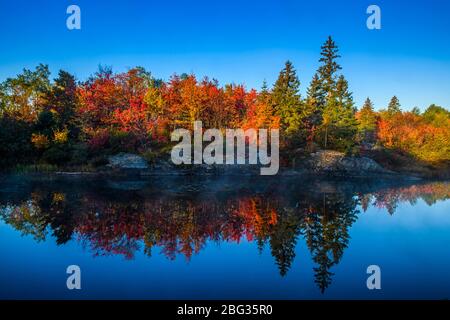 Autumn reflections in Fairbank Creek, Greater Sudbury (Walden), Ontario, Canada Stock Photo