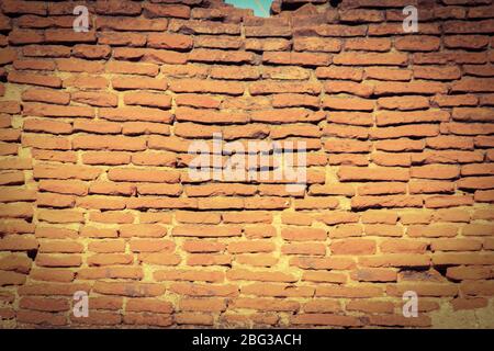 An unpainted brick wall in sepia forming a beautiful pattern and background Stock Photo