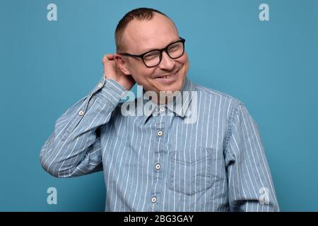 cheerful middle aged man giving thumb up on white background Stock Photo