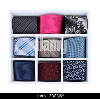 Neckties in wooden box isolated on white Stock Photo