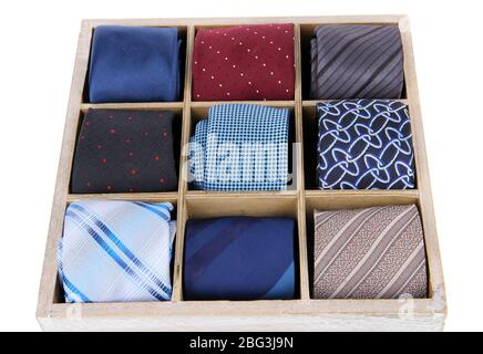 Neckties in wooden box isolated on white Stock Photo