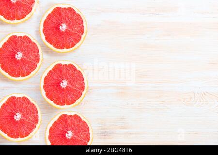 Fresh grapefruits on light blue background with copyspace Stock Photo