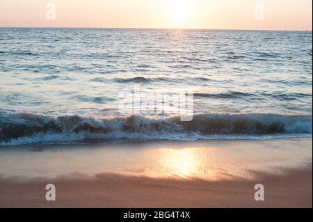 Sun setting over Pacific Ocean on beach in Mexico Stock Photo