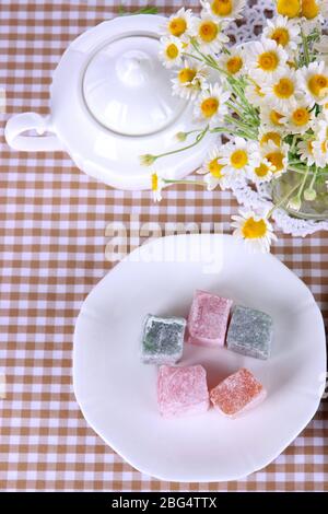 Table setting with chamomiles on checkered tablecloth Stock Photo