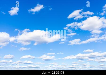 blue sky with many white small cumulus clouds on sunny March day Stock Photo