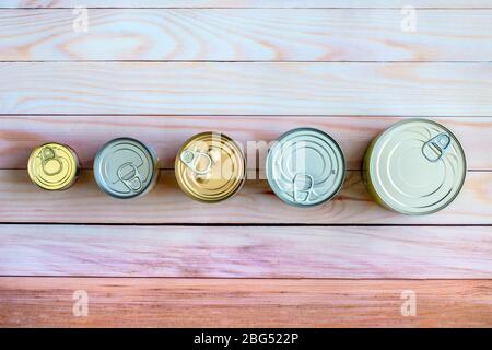 Overhead view row canned food in different sizes and colors. Stock non-perishable preserved food Stock Photo