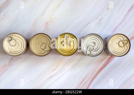 Overhead view row canned food in different sizes and colors. Stock non-perishable preserved food Stock Photo