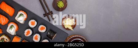 Banner format, different sushi rolls on black slate tray Stock Photo