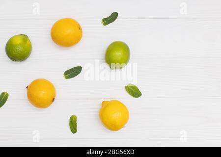 Creative composition with yellow lemons, green limes and mint sprigs Stock Photo