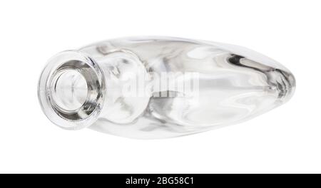 overturned empty clear cognac bottle isolated on white background Stock Photo
