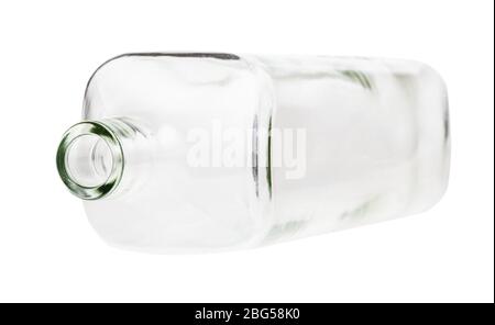 overturned empty clear whiskey bottle isolated on white background Stock Photo