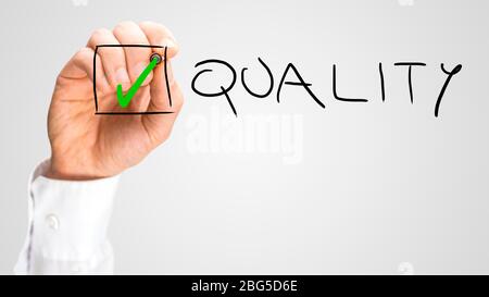 Hand Putting Small Green Check Inside Check Box for Quality. Isolated on Grey Background. Stock Photo