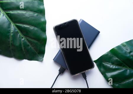 charging smartphone with power bank, high angle view Stock Photo