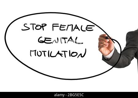 Man writing a large ringed oval sign - Stop Female Genital Mutilation - with a black marker pen on a white background, close up of his hand and the si Stock Photo