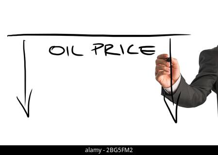 Dropping oil prices concept with a businessman drawing a graph with downward pointing arrows and the words - Oil Price - on a virtual screen or interf Stock Photo