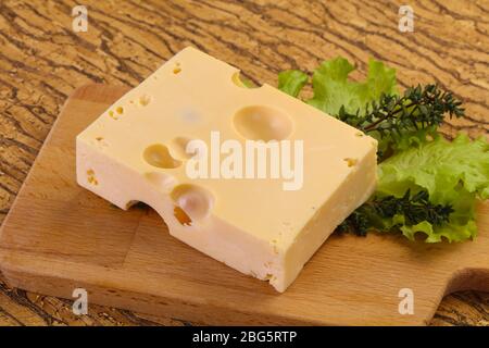 Maasdam cheese brick with thyme branch Stock Photo