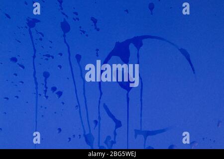 Drop of water on blue paper background. Abstract backdrop for your projects. Stock Photo