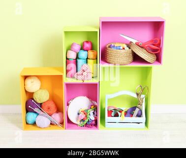 Colorful shelves of different colors with utensils on wall background Stock Photo