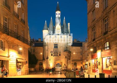 View of historical Porte Cailhau at night with full of people having dinner on restaurant terrace in Bordeaux, France Stock Photo