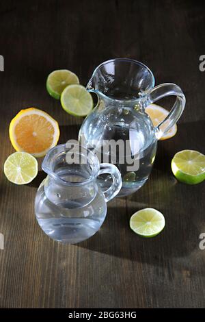 Glass pitchers of water on wooden table close-up Stock Photo - Alamy